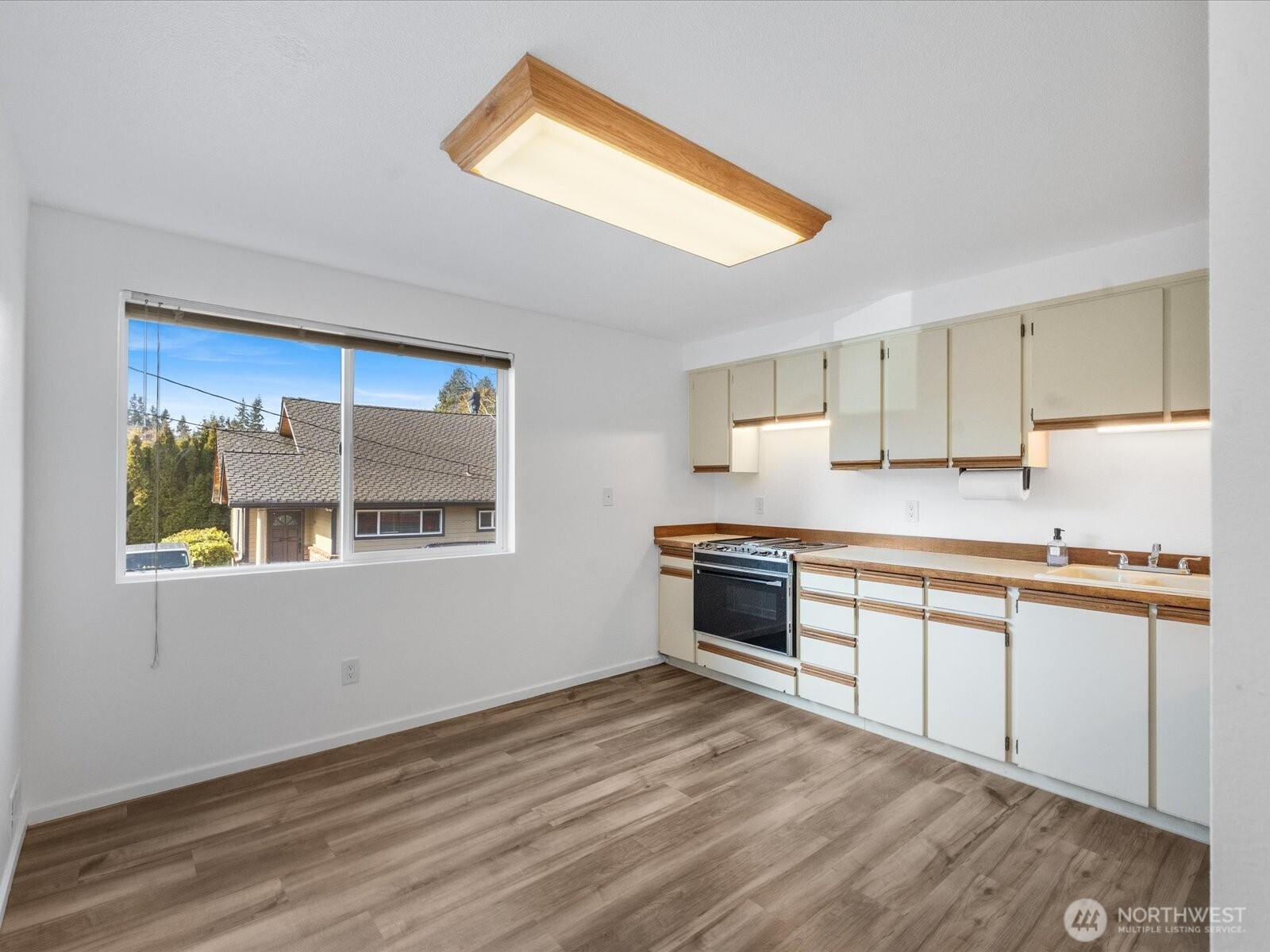 8225 212th Street Southwest, Unit 302 Edmonds, WA 98026 - Photo 3 of 16 a kitchen with granite countertop a stove and a sink