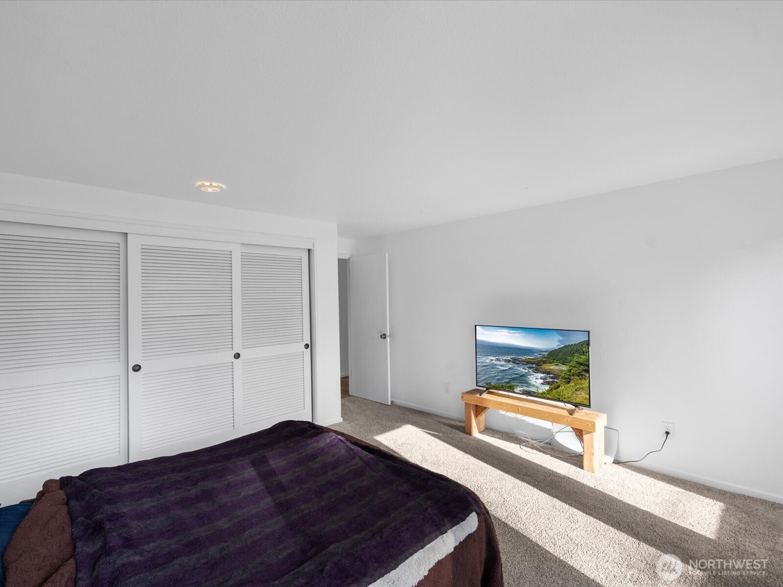 8225 212th Street Southwest, Unit 302 Edmonds, WA 98026 - Photo 8 of 16 a bedroom with a bed and a painting on the wall