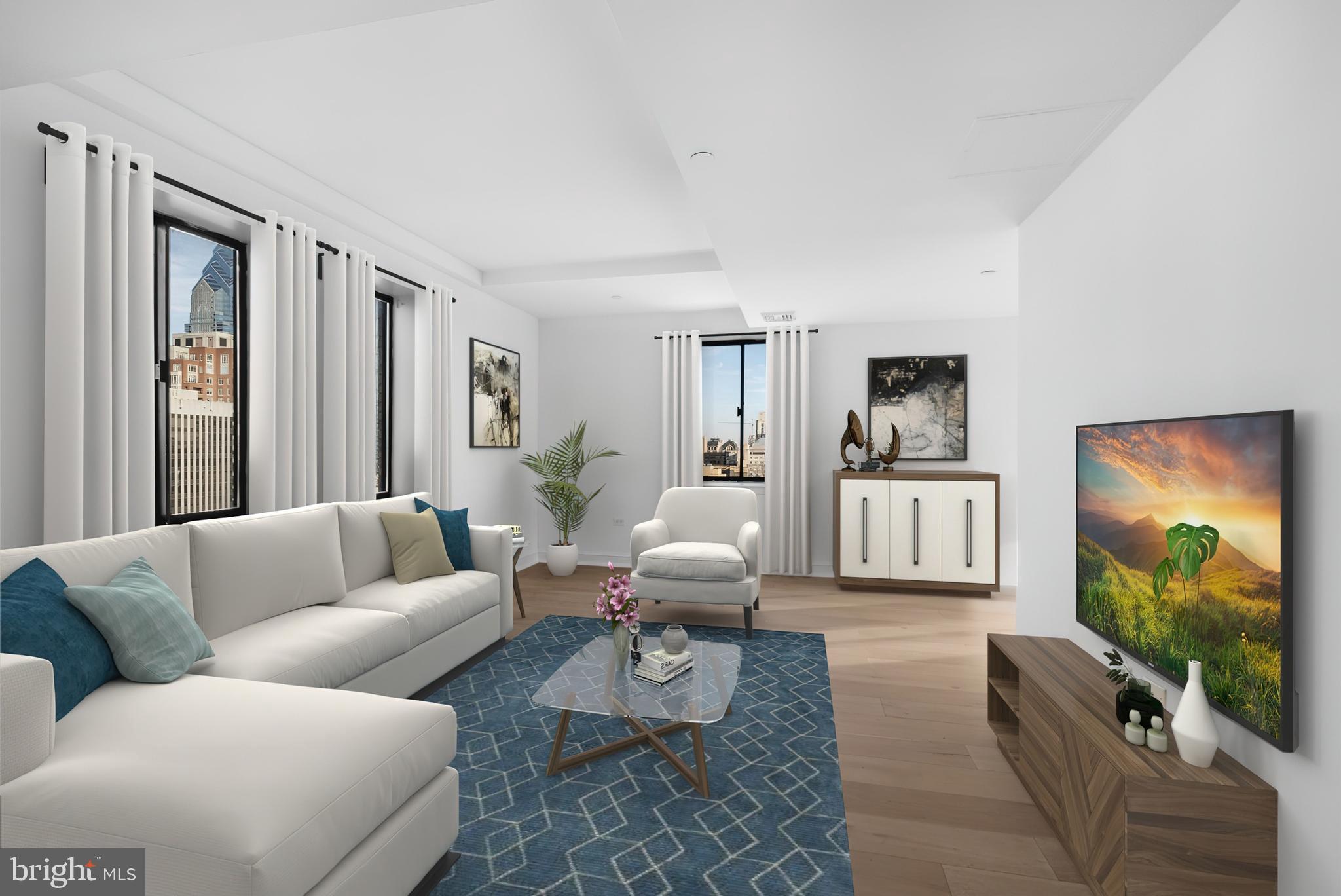 a living room with furniture a rug and a flat screen tv