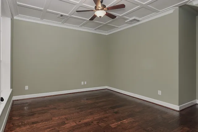 a living room with wooden floor and a fireplace