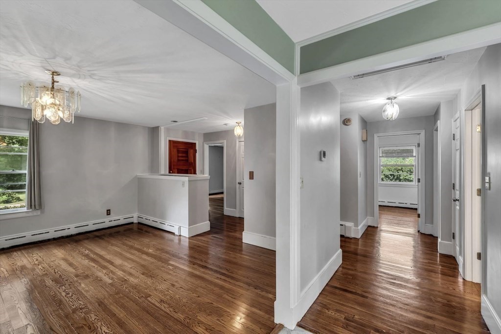 1164 High Street Bridgewater, MA 02324 - Photo 12 of 29 a view of a hallway with wooden floor and a bathroom