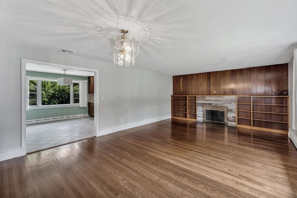 1164 High Street Bridgewater, MA 02324 - Photo 2 of 29 an empty room with wooden floor fireplace and windows