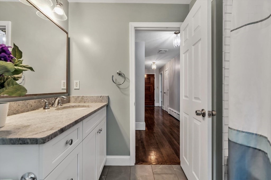 1164 High Street Bridgewater, MA 02324 - Photo 22 of 29 a bathroom with a granite countertop sink and a mirror