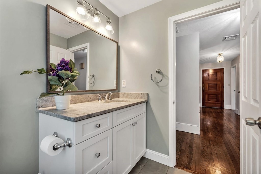 1164 High Street Bridgewater, MA 02324 - Photo 23 of 29 a bathroom with a granite countertop sink a mirror and a shower