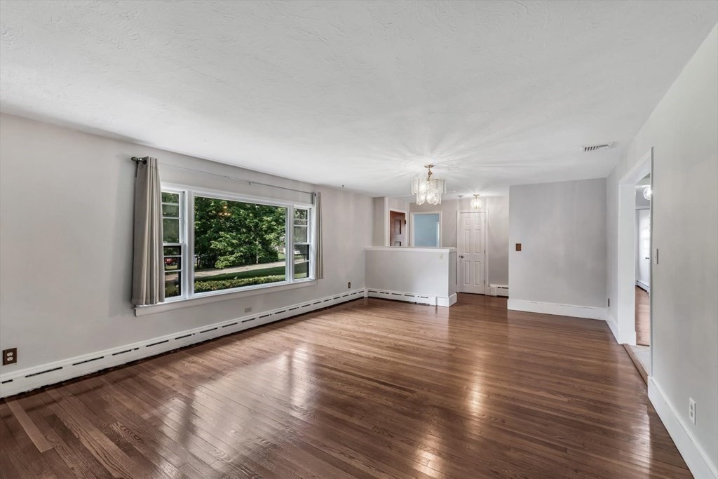 1164 High Street Bridgewater, MA 02324 - Photo 3 of 29 a view of an empty room with wooden floor and a window