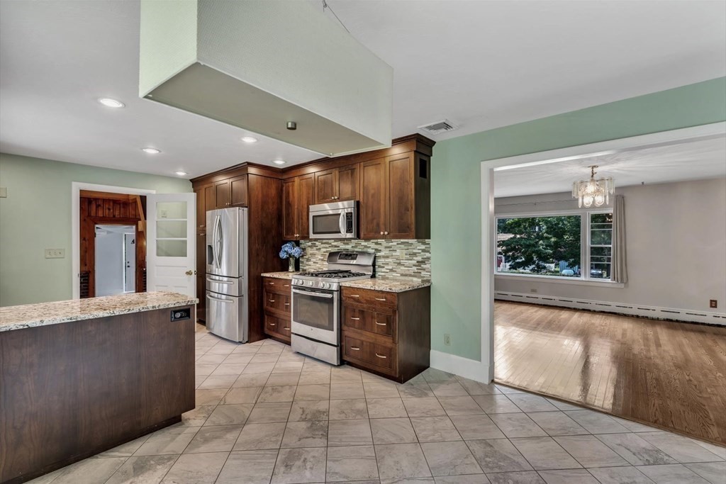 1164 High Street Bridgewater, MA 02324 - Photo 4 of 29 a large kitchen with stainless steel appliances kitchen island granite countertop a refrigerator oven a sink and dishwasher