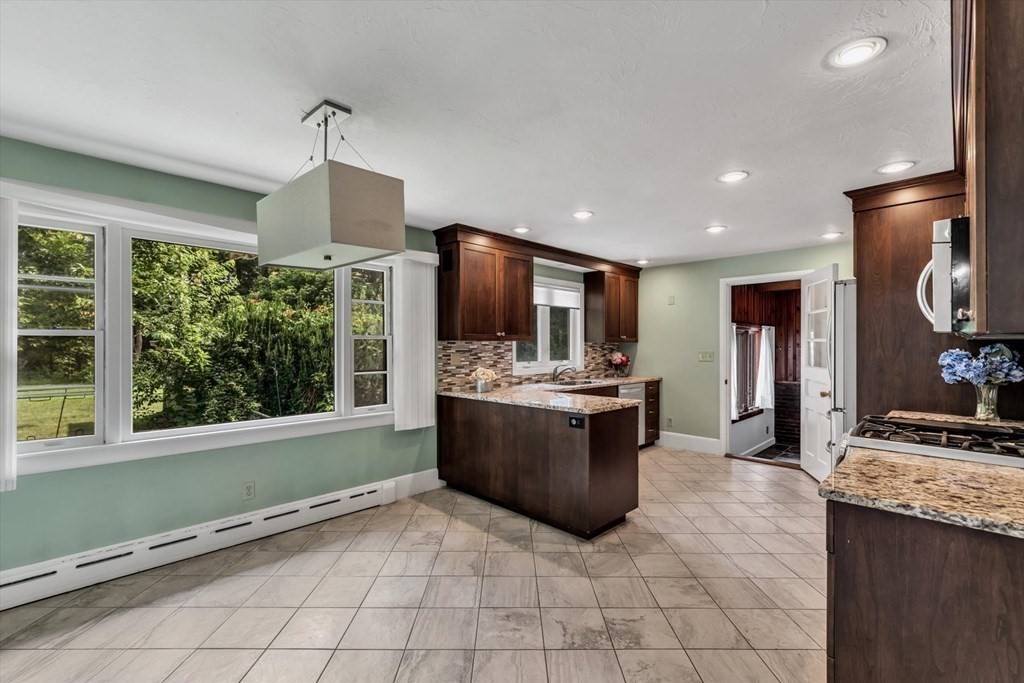 1164 High Street Bridgewater, MA 02324 - Photo 7 of 29 a large kitchen with stainless steel appliances granite countertop a stove and a sink