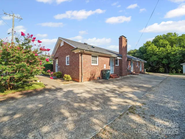 a front view of a house with a yard and a garage