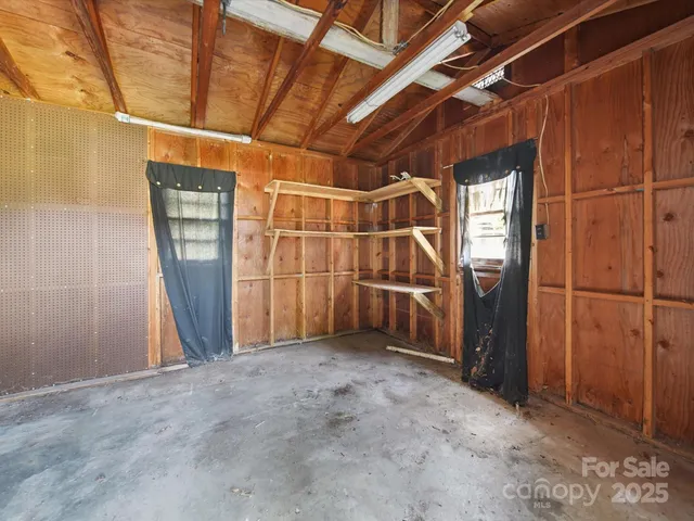 a view of empty room with wooden walls