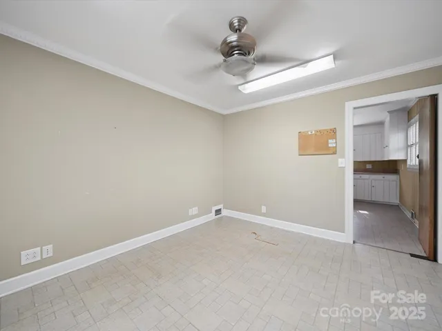 an empty room with a ceiling fan and a window