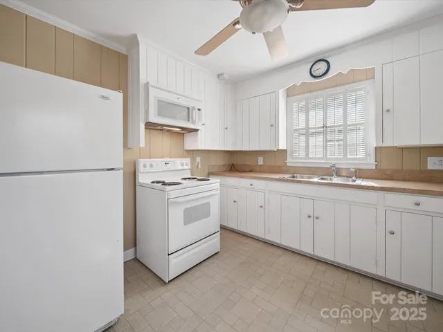 a kitchen with cabinets appliances and a window