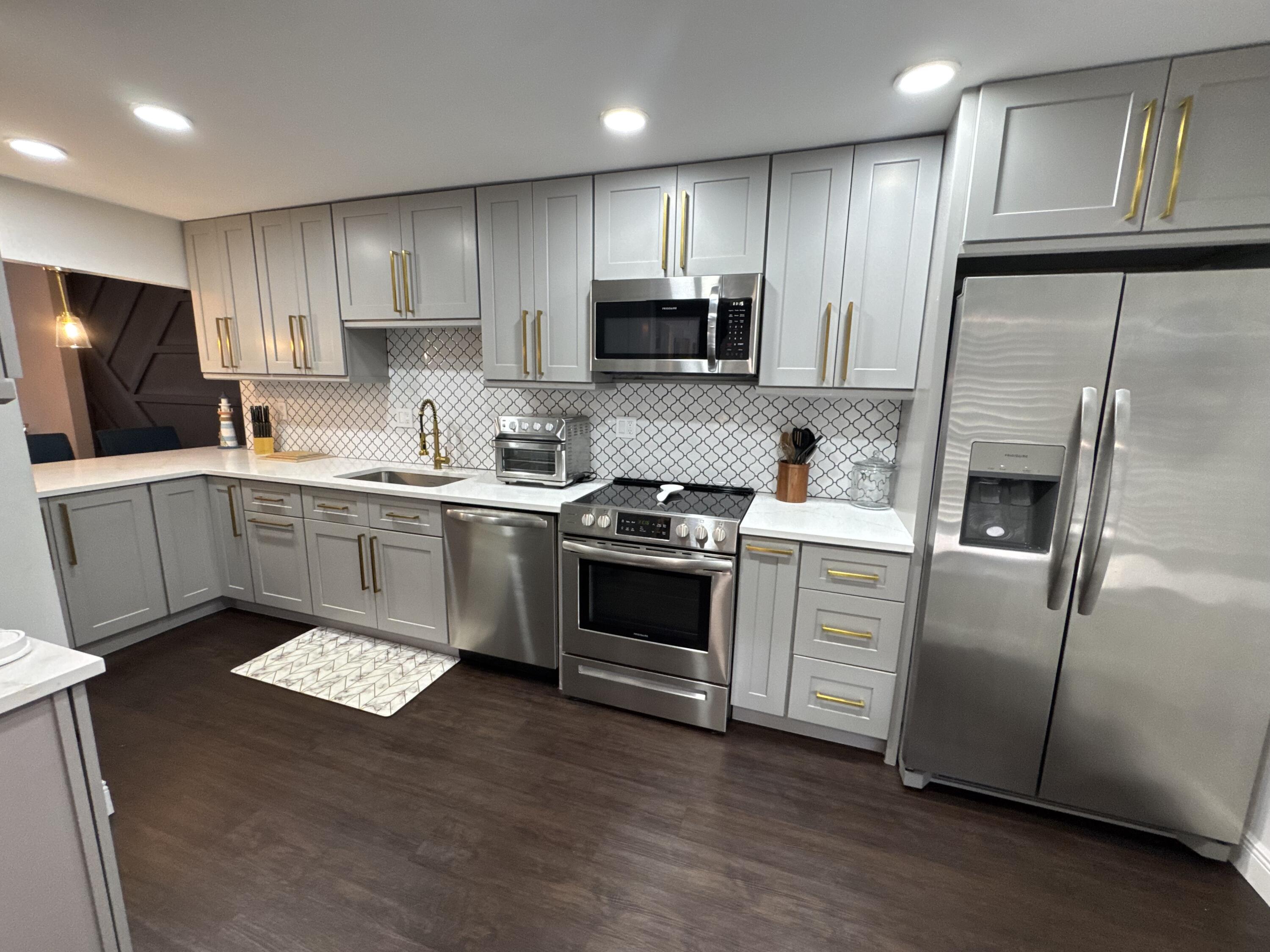 6 Royal Palm Way, Unit 202 Boca Raton, FL 33432 - Photo 14 of 29 a kitchen with a sink stainless steel appliances and cabinets