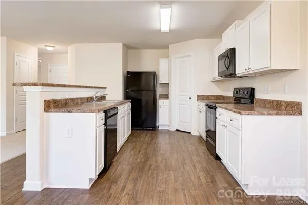 a kitchen with a stove top oven sink and refrigerator