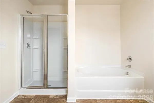 a bathroom with a bathtub and a shower