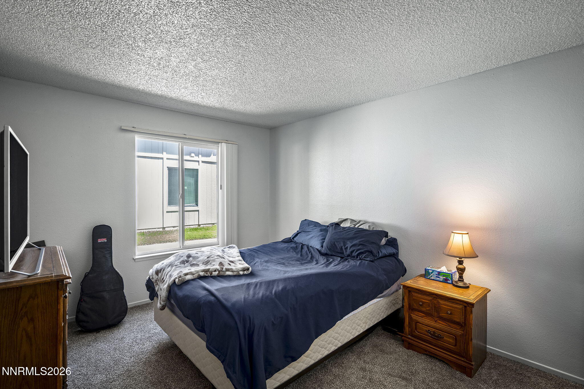 400 South Saliman Road, Unit 129 Carson City, NV 89701 - Photo 8 of 15 a bedroom with a bed and a window