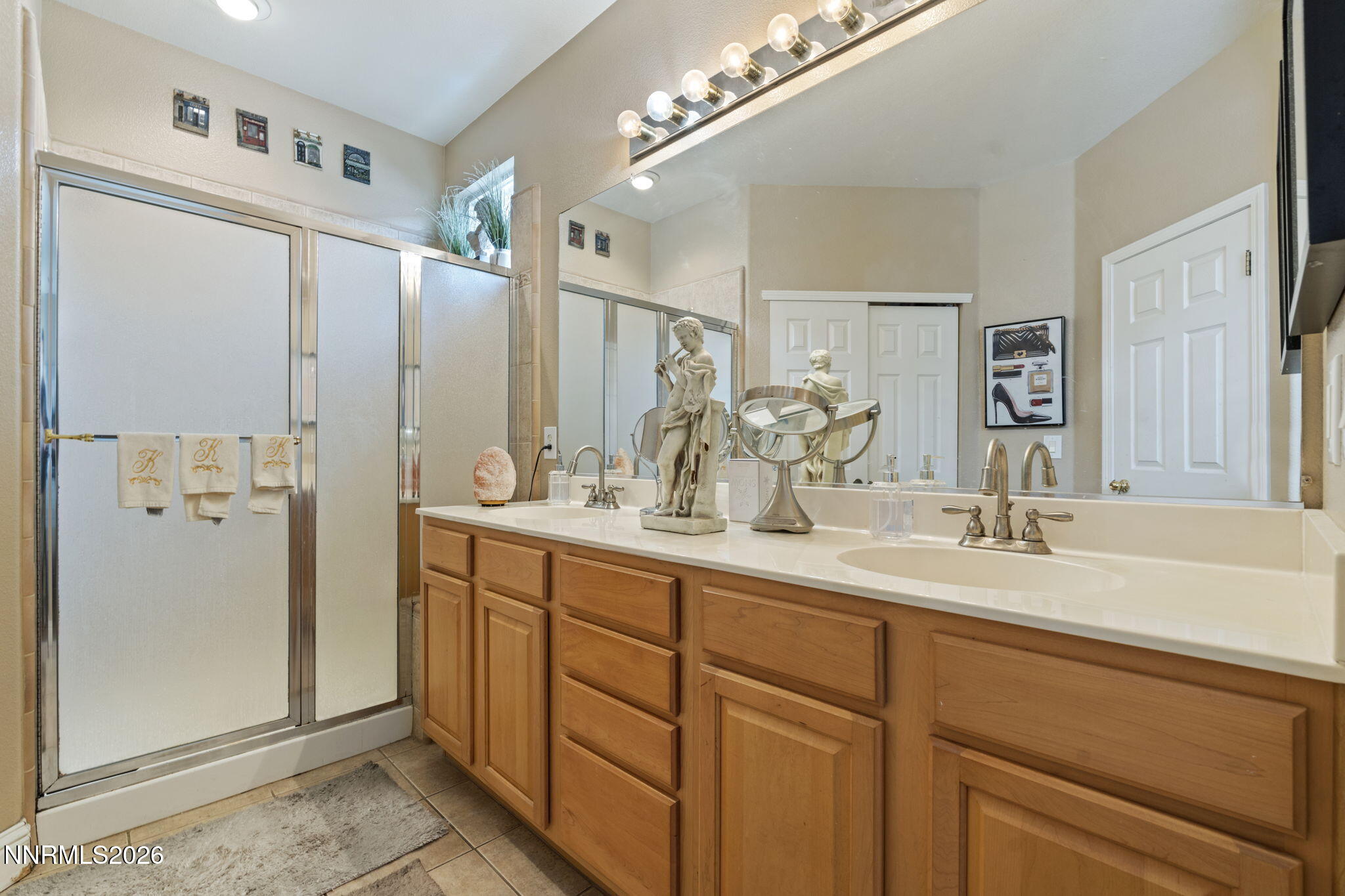 1600 Mountain Lane Reno, NV 89521 - Photo 16 of 24 a bathroom with a double vanity sink and mirror