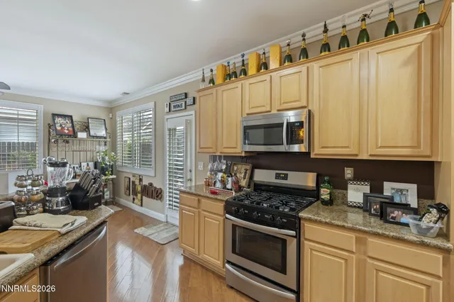a kitchen with stainless steel appliances granite countertop a stove a sink and a microwave