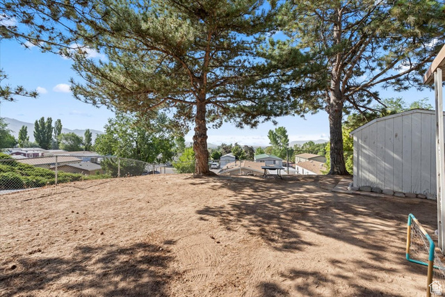 2875 North Hill Field Road, Unit 17 Layton, UT 84041 - Photo 15 of 23 View of yard featuring a mountain view and a shed