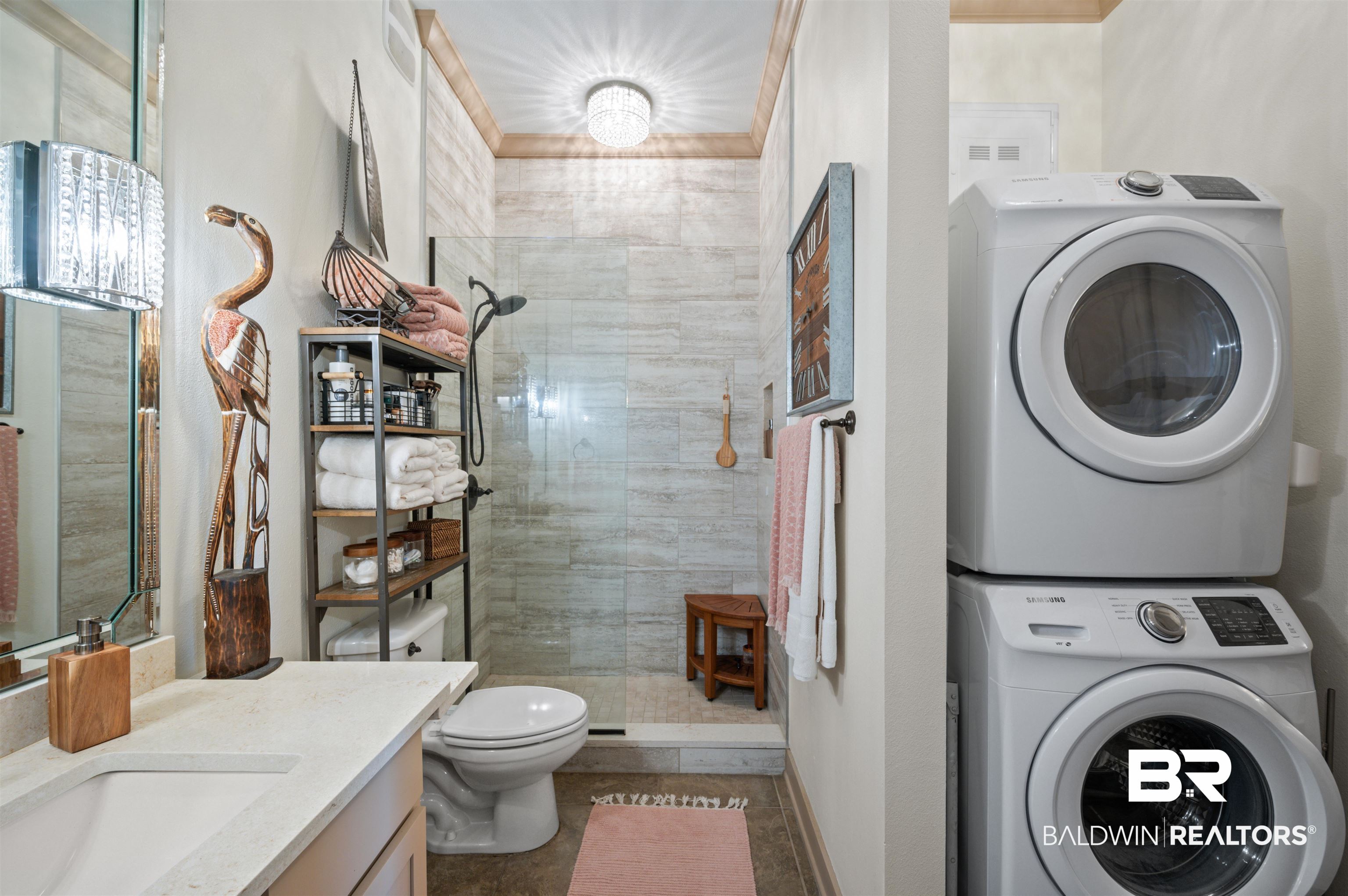 1430 Regency Road, Unit B202 Gulf Shores, AL 36542 - Photo 17 of 33 Bathroom featuring tiled shower, stacked washer / dryer, vanity, and toilet