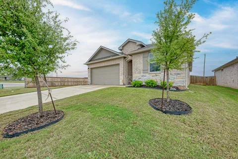 a front view of a house with a yard