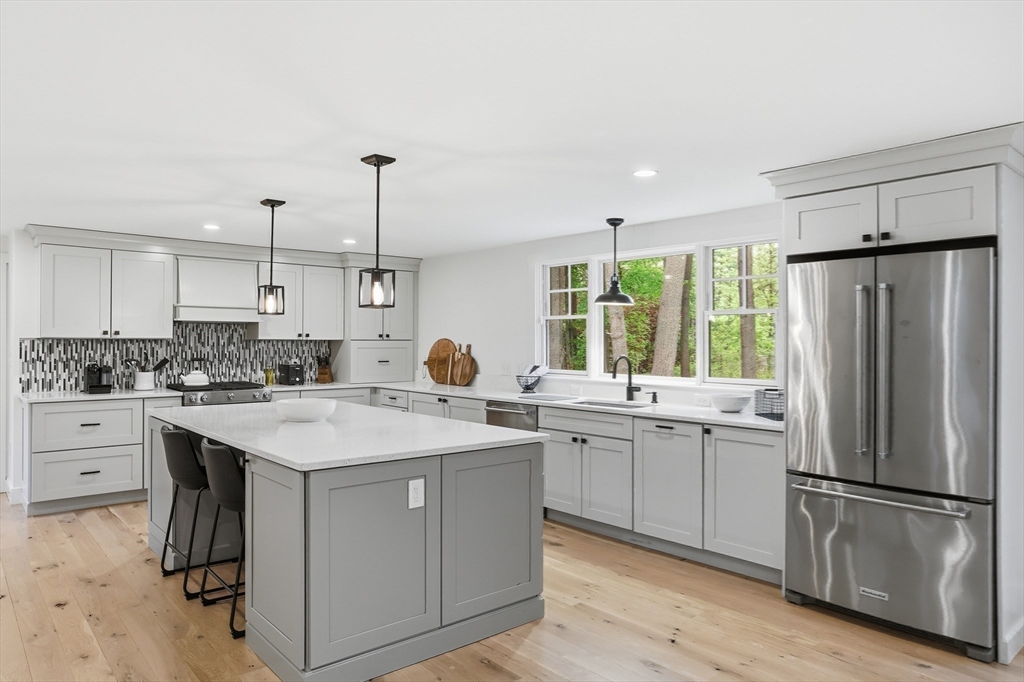136 Holden Wood Road Concord, MA 01742 - Photo 28 of 31 a kitchen with a sink a stove a refrigerator and white cabinets