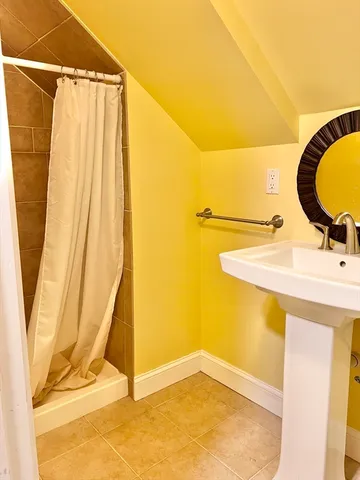 a bathroom with a granite countertop toilet a sink and a bathtub
