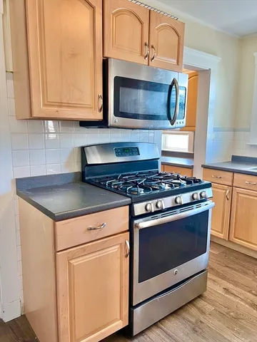 a kitchen with a stove and a microwave