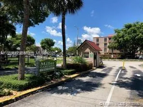a front view of a house with a yard and potted plants