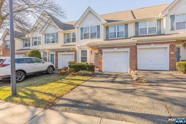 a view of a brick house with many windows