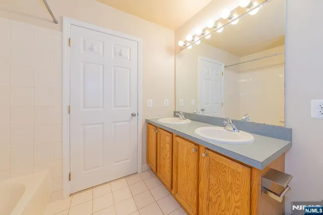 a bathroom with a double vanity sink and a mirror