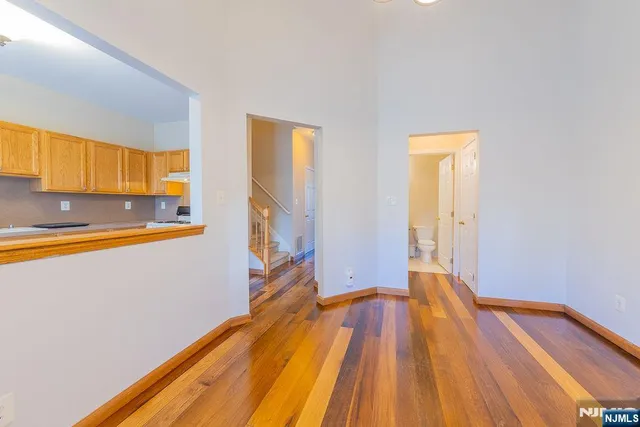 a view of a room with wooden floor and a bed