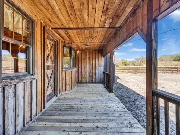 a view of a porch with wooden floor and outdoor space
