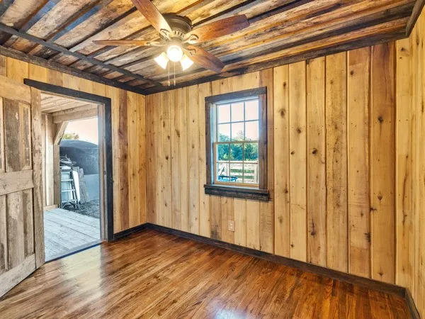a view of a room with wooden floor and windows