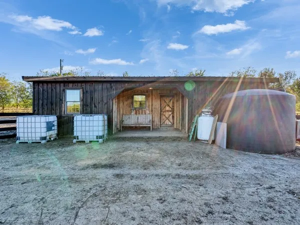 a view of a house with wooden fence