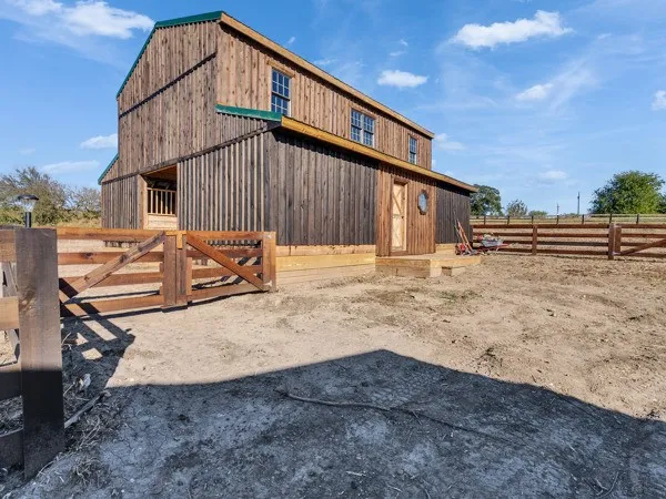 a view of a house with wooden fence
