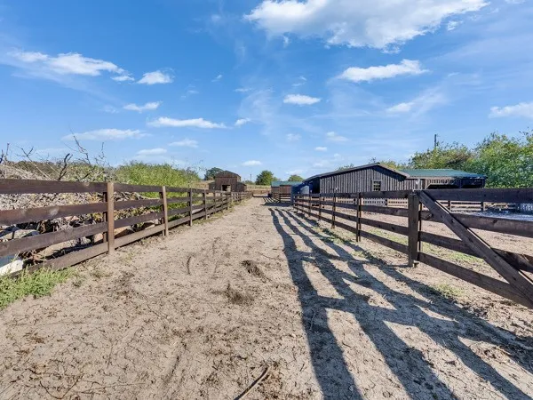 a view of a backyard with wooden fence