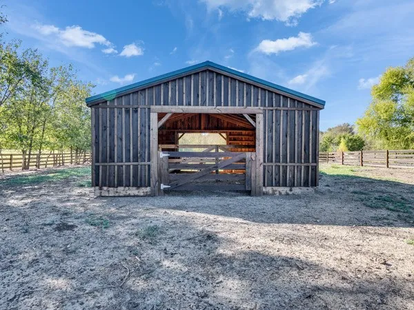 a view of a room with wooden floor and iron stairs