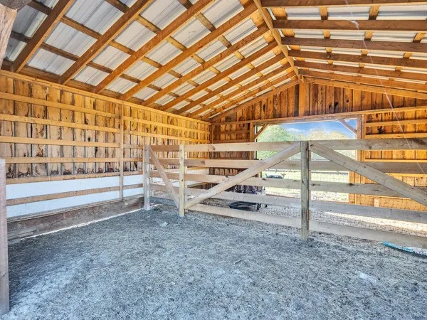 a view of a room with wooden floor and iron stairs