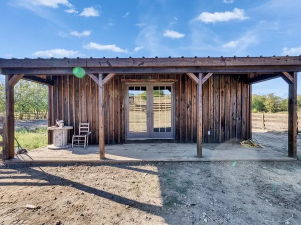 a view of a house with backyard and chairs