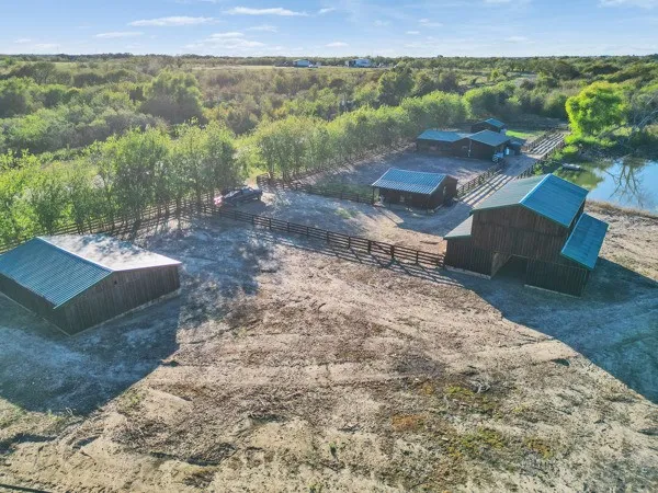 an aerial view of a houses with a yard