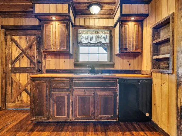 a kitchen with stainless steel appliances granite countertop a refrigerator and a dishwasher next to a window
