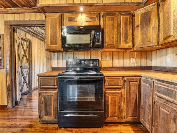 a kitchen with stainless steel appliances granite countertop a stove and a microwave