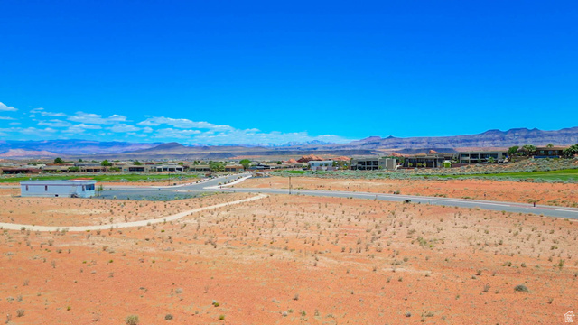 3306 South Endless Trail, Unit 33 Hurricane, UT 84737 - Photo 26 of 27 Expansive undeveloped land featuring a paved road, dirt paths, and distant residential structures