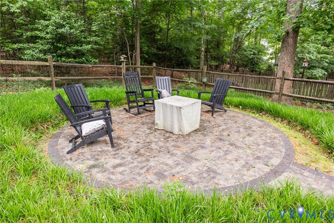 5603 Standing Oak Road Midlothian, VA 23112 - Photo 38 of 43 Circular paver patio with a stone fire feature and