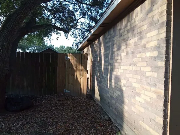 a view of a pathway of a house with a yard