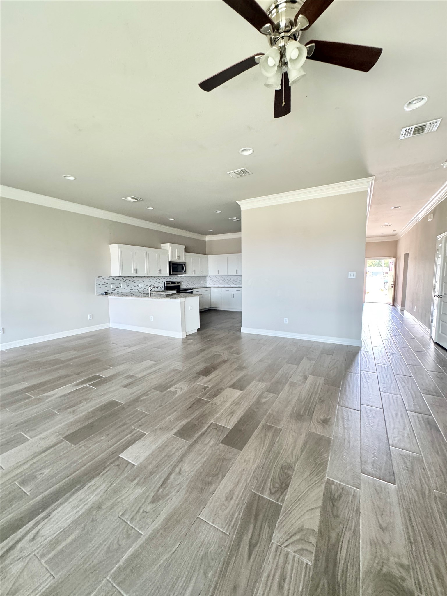 105 Everett Court, Unit B Jarrell, TX 76537 - Photo 12 of 16 wooden floor in an empty room with a window