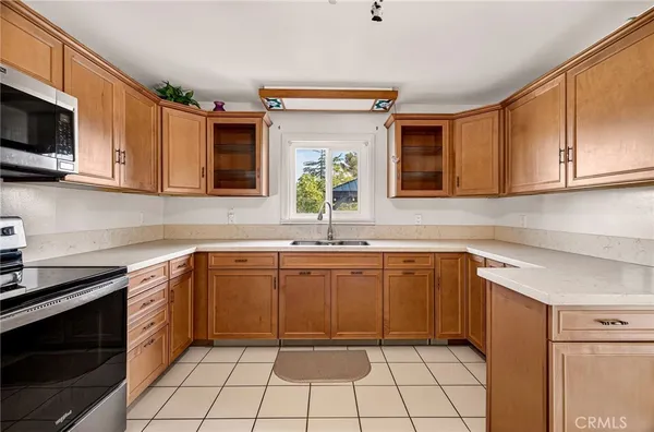 a kitchen with a sink and potted plant
