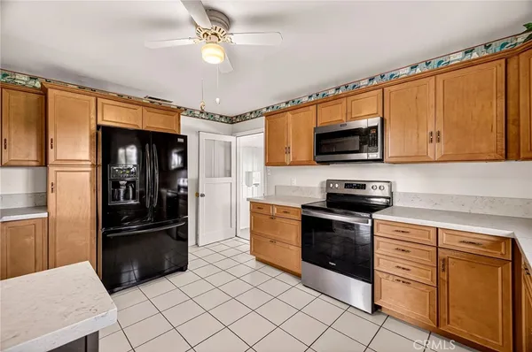 a kitchen with a refrigerator a sink and cabinets