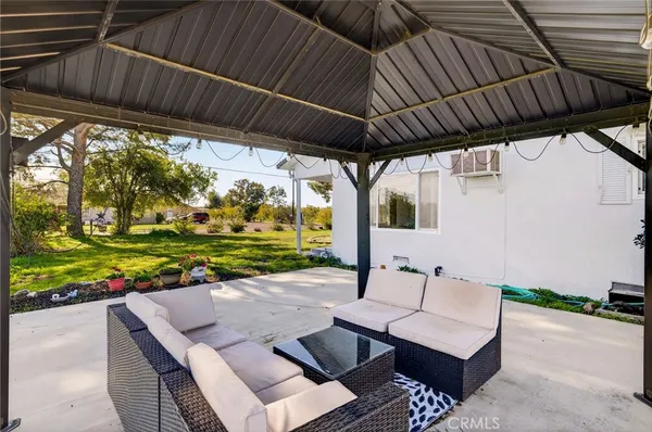 a view of a house with a yard and sitting area