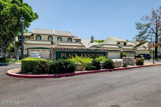 a front view of a building with a garden